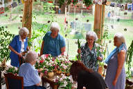 Dorothy, Nancy, Anne, Dona and Mary arranging flowers