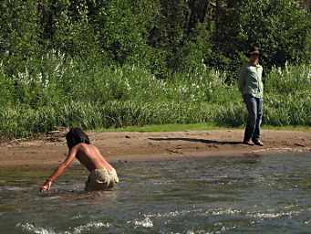 Zia crossing the creek, Adin looking on