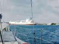 Tug getting line from Freighter