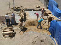 Alfred, Michelle, Juana and Erin mixing straw with clay