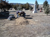 Dona and Gary putting flowers on Dad's grave